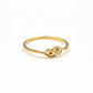 Gold ring on a gray background with weight and code label.