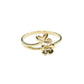 Gold ring with floral design on a gray background