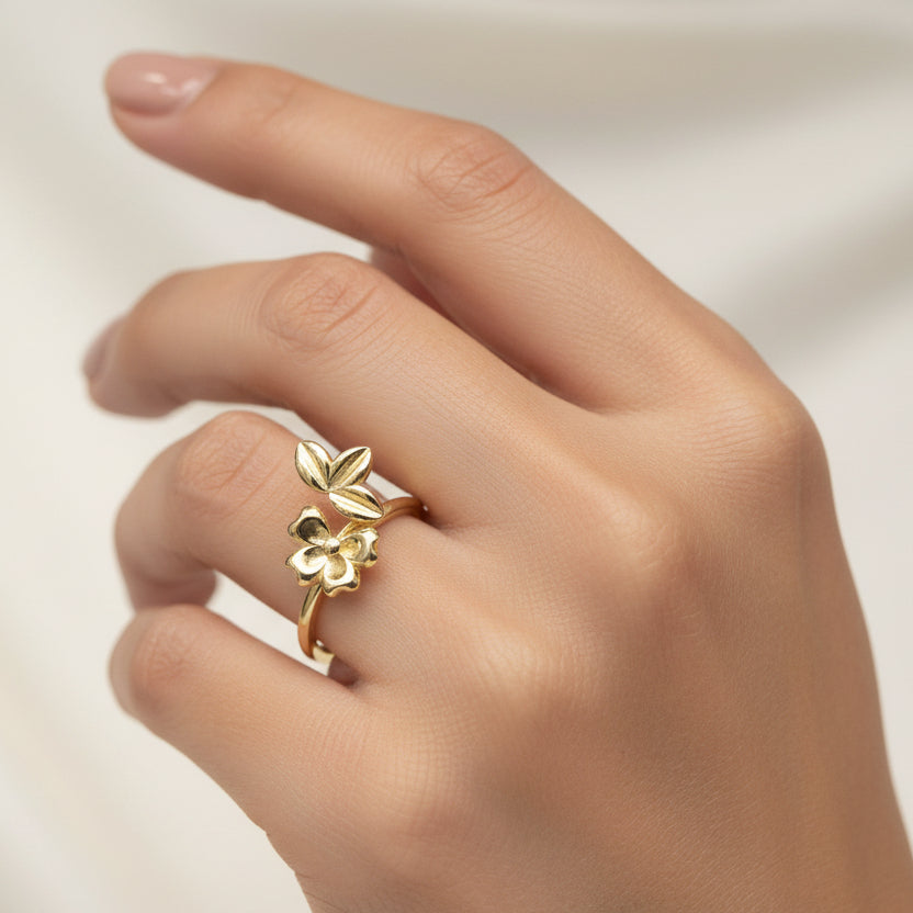 Gold ring with butterfly design on a white background