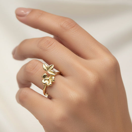 Gold ring with butterfly design on a white background