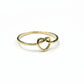 Gold ring with a knot design on a gray background