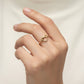 Gold infinity ring on a white background