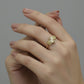 Gold ring with geometric design on a gray background