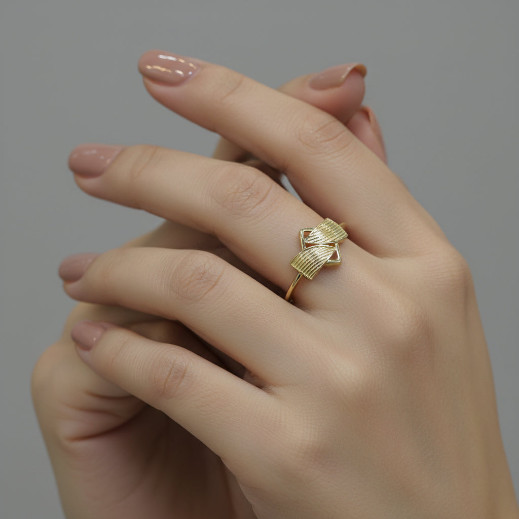Gold ring with geometric design on a gray background