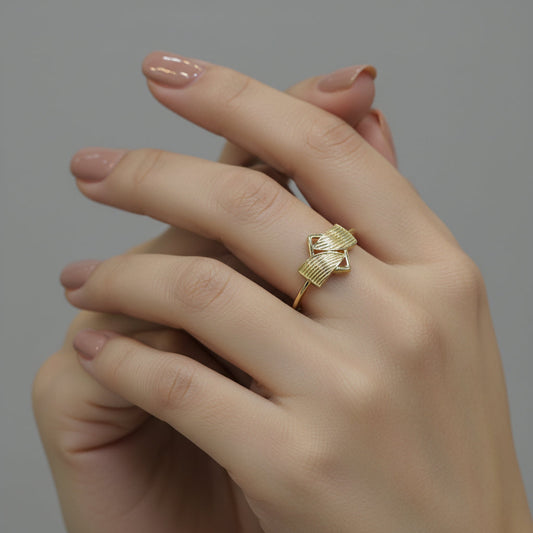 Gold ring with geometric design on a gray background