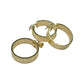 Gold hoop earrings with engraved design on a light gray background