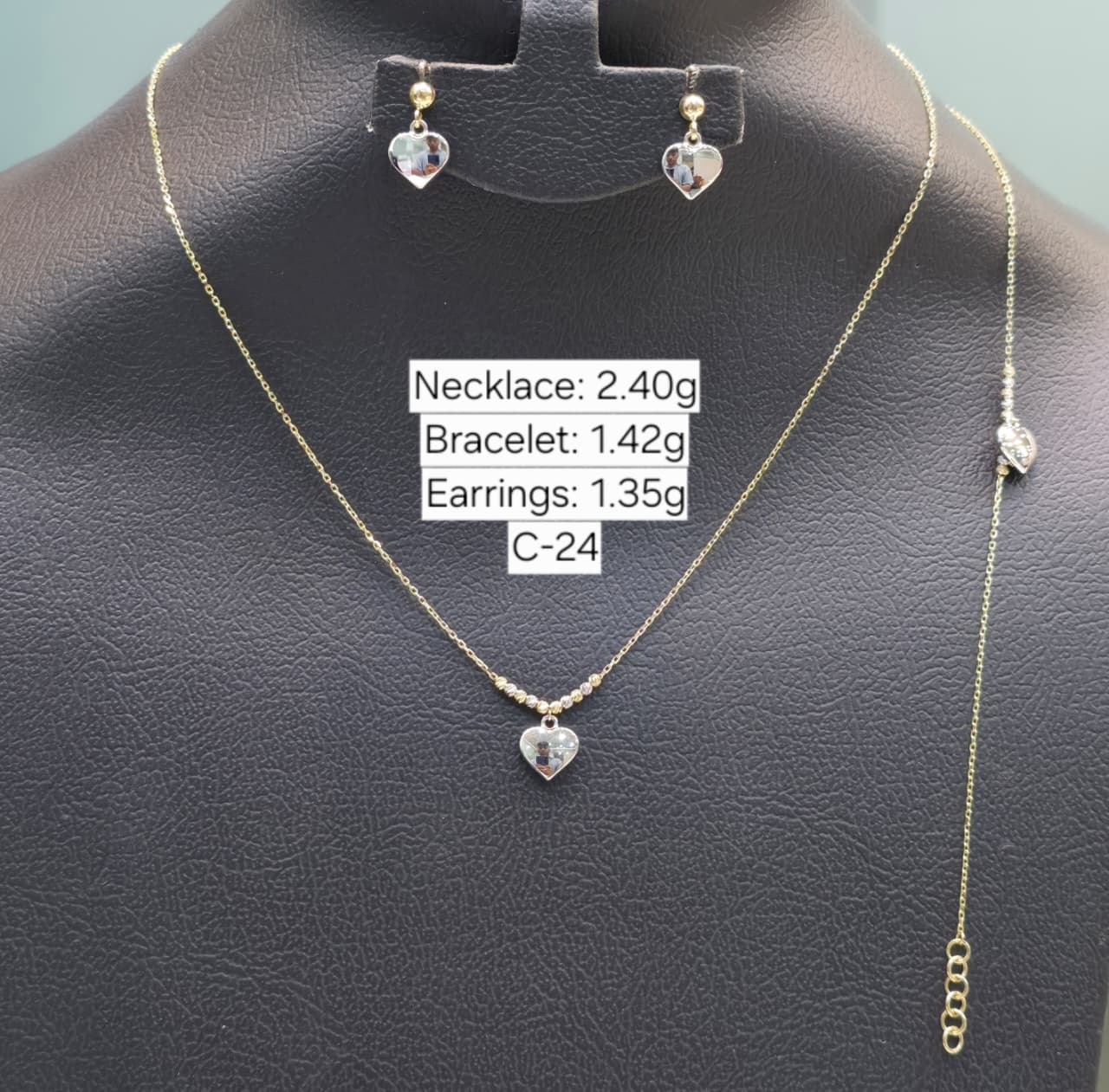 Jewelry set including necklace, bracelet, and earrings on a black mannequin with weight labels.