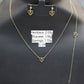 Gold necklace, bracelet, and earrings on a black background with weight labels.