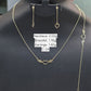 Gold necklace, bracelet, and earrings on a black stand with weight labels.