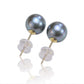 Pair of pearl earrings with gold and clear components on a white background