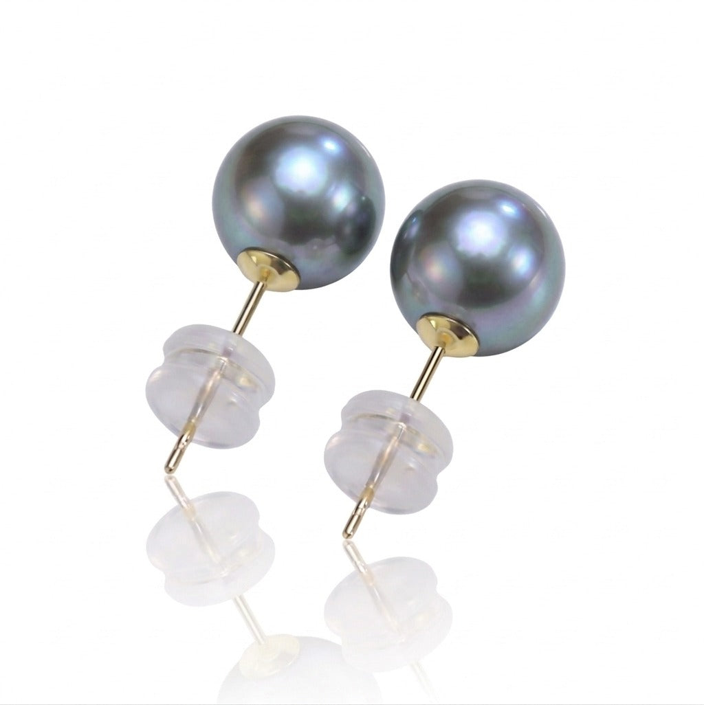 Pair of pearl earrings with gold and clear components on a white background