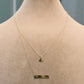 Gold necklace with a heart pendant on a mannequin, displayed against a neutral background.