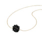 Necklace with a black floral pendant on a white background