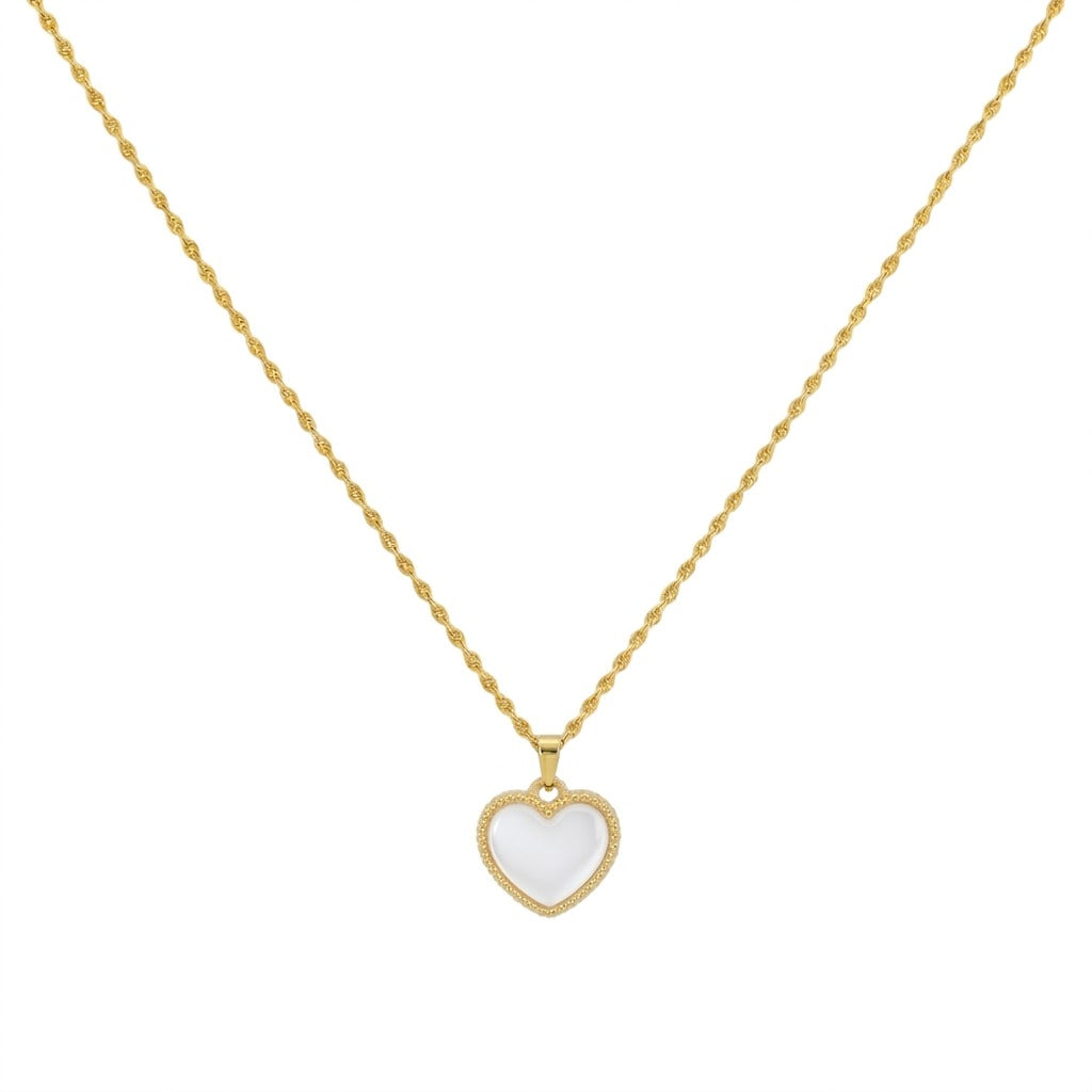 Gold necklace with a heart-shaped pendant on a white background