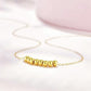 Gold beaded bracelet on a light pink background