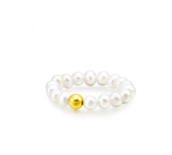 Pearl bracelet with a gold bead on a white background