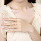 Close-up of a hand wearing two rings with a blurred background