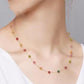 Necklace with multicolored beads worn by a person on a plain background
