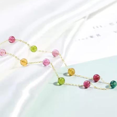 Necklace with multicolored beads on a light background