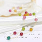 Colorful beaded necklace on a white surface with blurred background