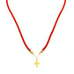Red cord necklace with a gold cross pendant on a white background