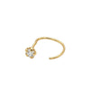 Gold nose ring with a small diamond on a light gray background