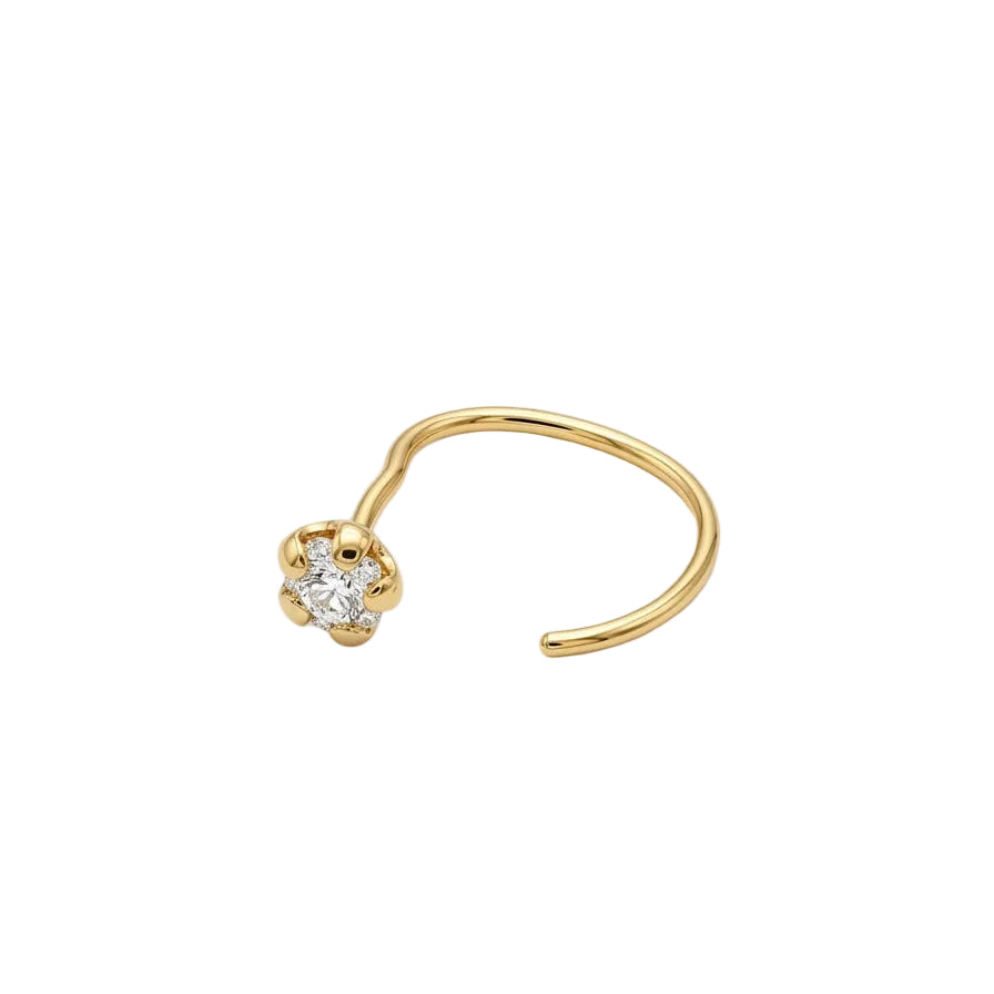Gold nose ring with a small diamond on a light gray background