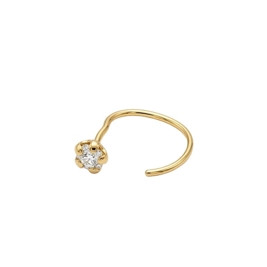 Gold nose ring with a small diamond on a light gray background