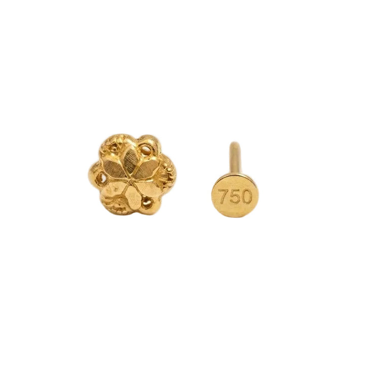 Gold earring with floral design on a white background