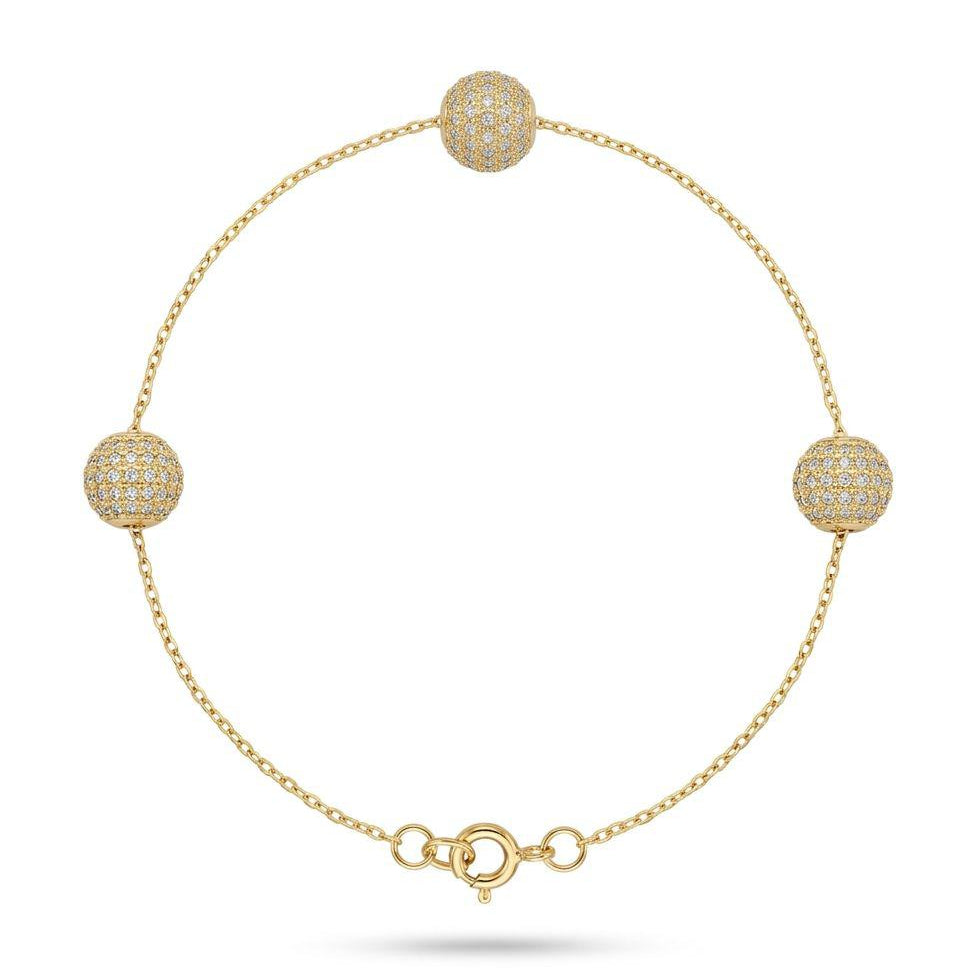 Gold bracelet with spherical beads on a white background
