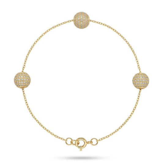 Gold bracelet with spherical beads on a white background