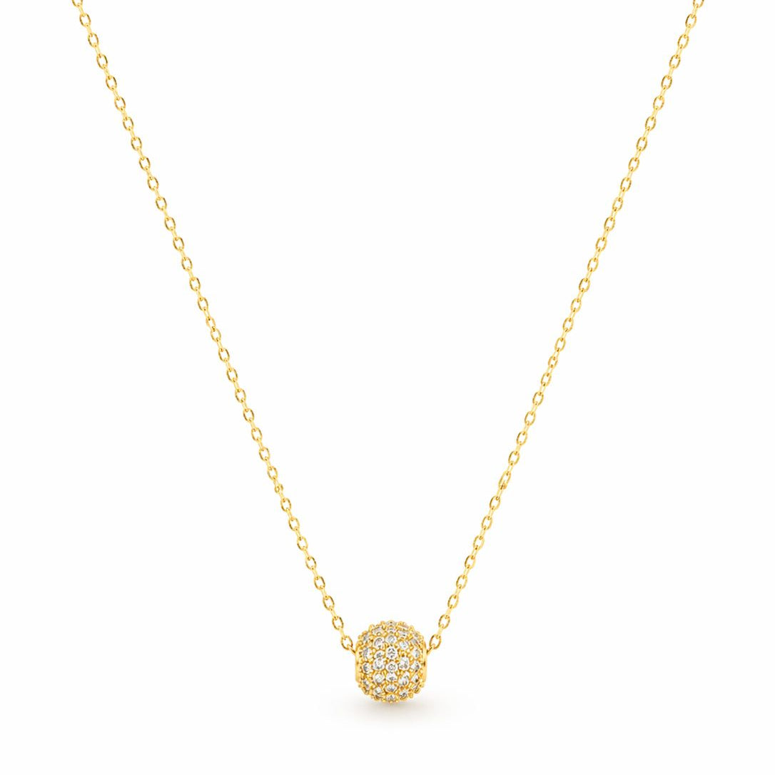 Gold necklace with a round pendant on a white background