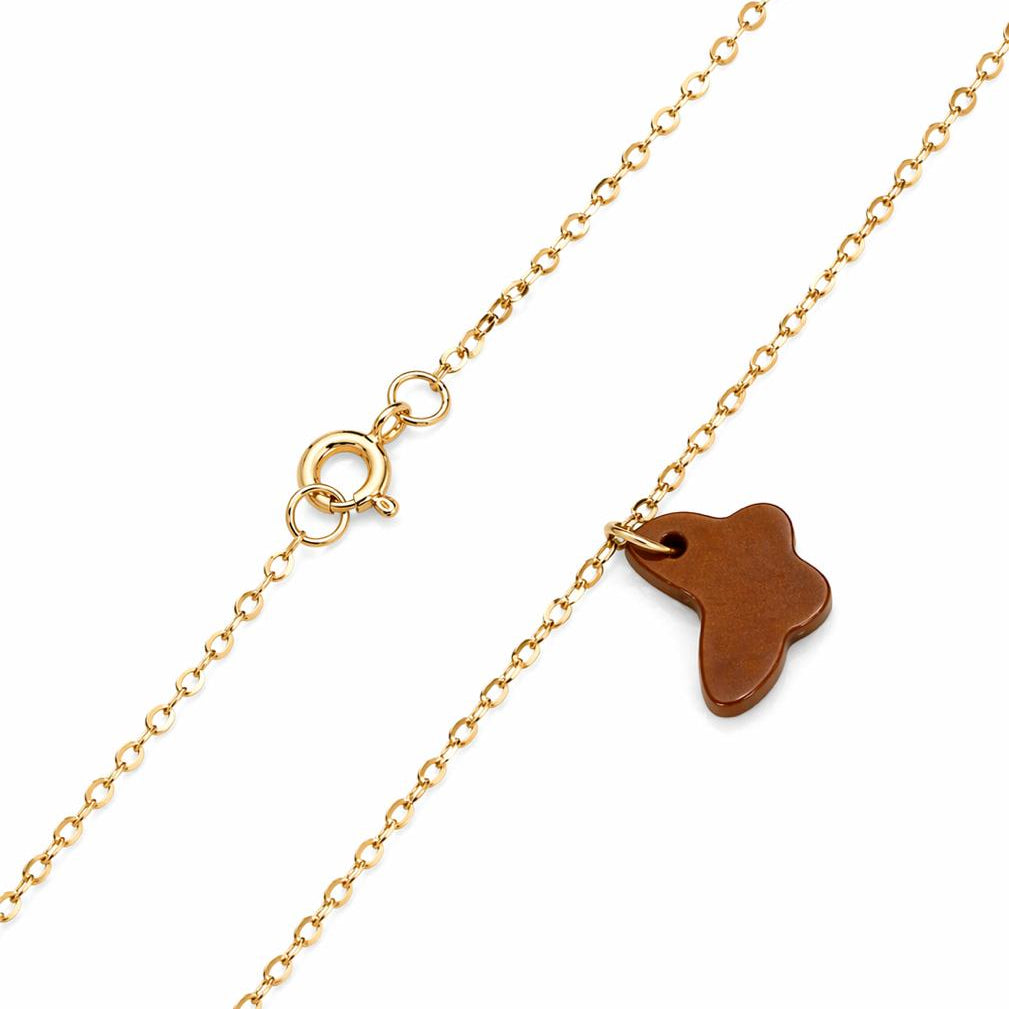 Gold chain necklace with a brown leather tag on a white background