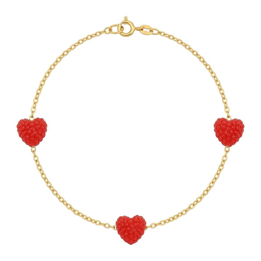 Gold bracelet with red heart-shaped charms on a white background