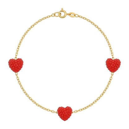 Gold bracelet with red heart-shaped charms on a white background