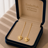 Gold heart-shaped earrings in a 'Embellish Gold Jewelry & Diamond' box.