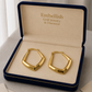 Gold hoop earrings in a 'Embellish Gold Jewelry & Diamond' box.