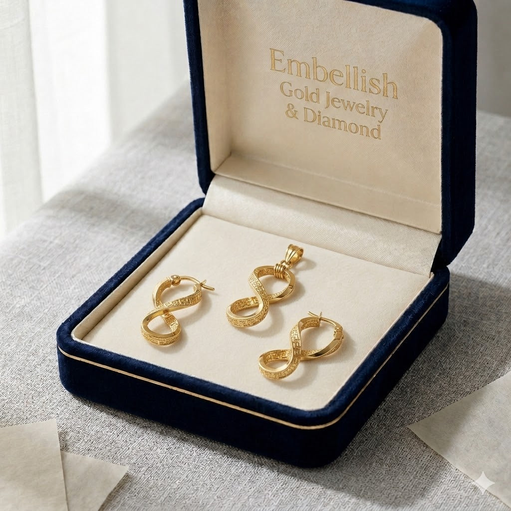 Gold earrings in a 'Embellish Gold Jewelry & Diamond' box on a textured surface.