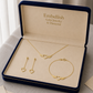 Gold jewelry set including necklace, earrings, and bracelet in an 'Embellish' box.