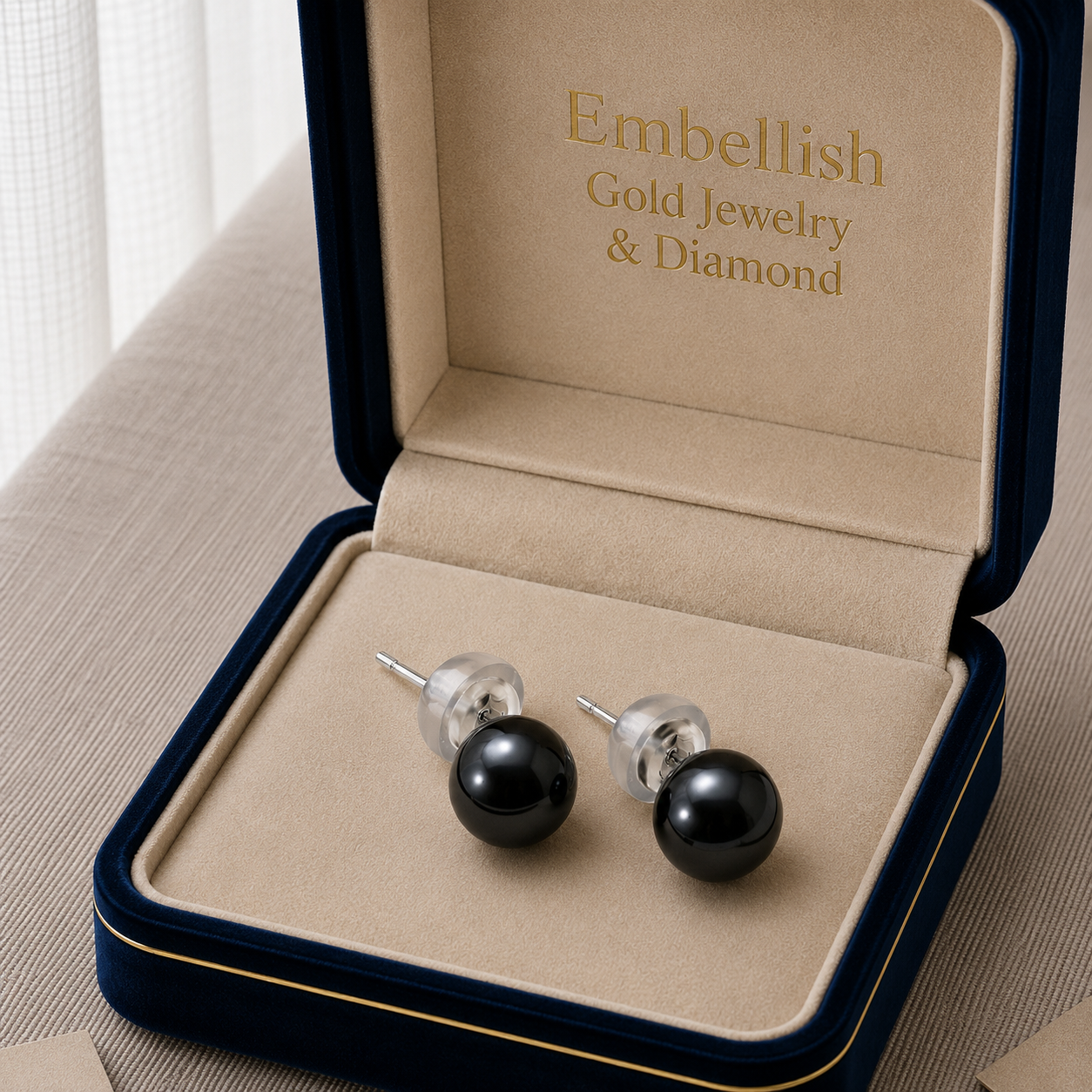 Black pearl earrings in a 'Embellish Gold Jewelry & Diamond' box.