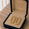 Gold hoop earrings in a 'Embellish Gold Jewelry & Diamond' box.
