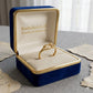 Gold ring in a blue jewelry box with 'Embellish Gold Jewelry & Diamond' text.