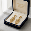 Gold leaf earrings in a 'Embellish Gold Jewelry & Diamond' box.