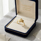 Gold ring in an open jewelry box with 'Embellish Gold Jewelry & Diamond' branding.
