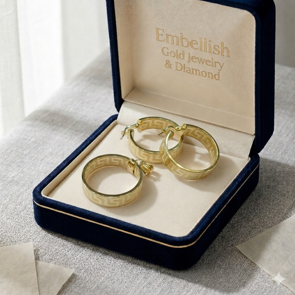 Gold hoop earrings in a 'Embellish Gold Jewelry & Diamond' box on a textured surface.