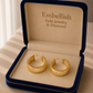 Gold hoop earrings in a 'Embellish Gold Jewelry & Diamond' box.