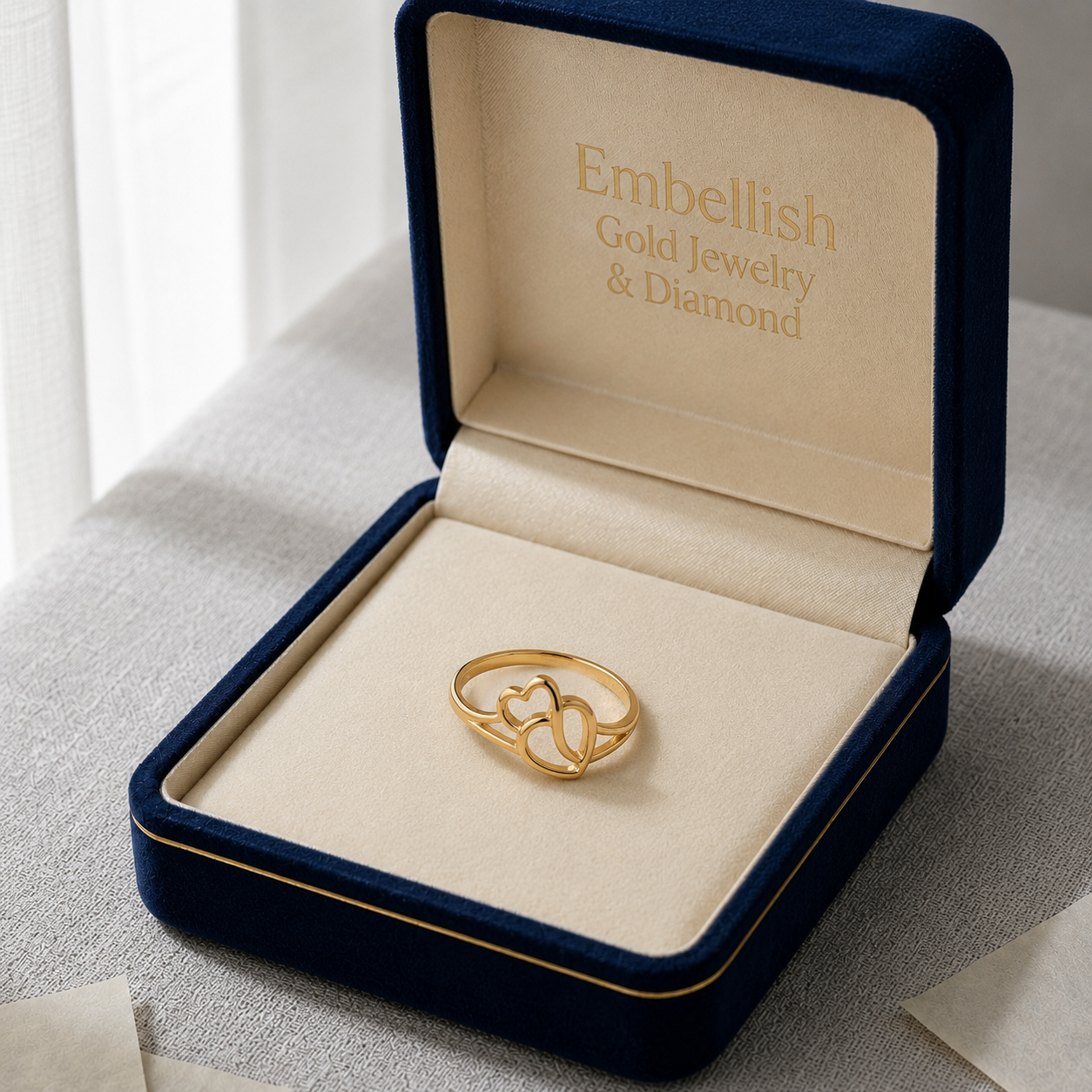 Gold ring in a 'Embellish Gold Jewelry & Diamond' box on a light surface.