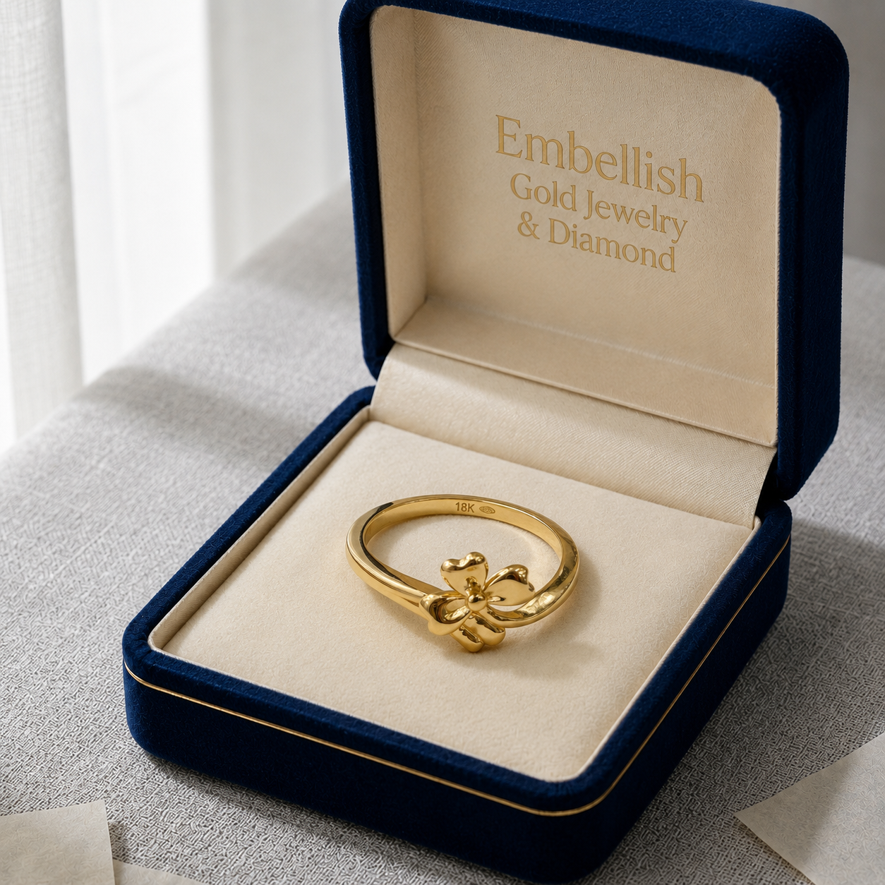 Gold ring in a blue jewelry box with 'Embellish Gold Jewelry & Diamond' branding.
