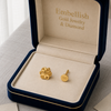 Gold earrings in a 'Embellish Gold Jewelry & Diamond' box on a light background