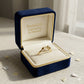 Gold ring in a blue jewelry box with 'Embellish Gold Jewelry & Diamond' text.